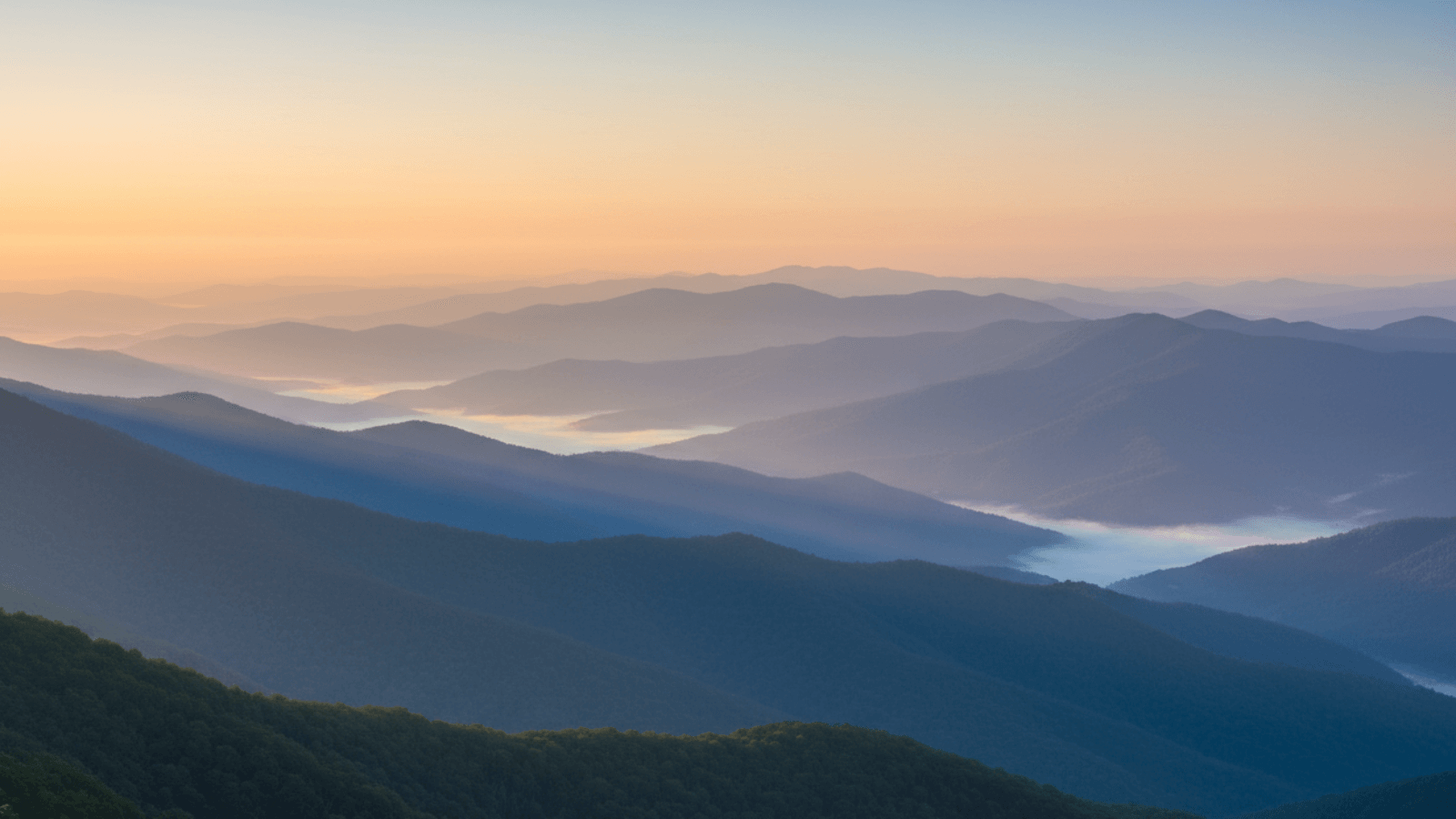 Hazy mountain landscape with a soft gradient sky